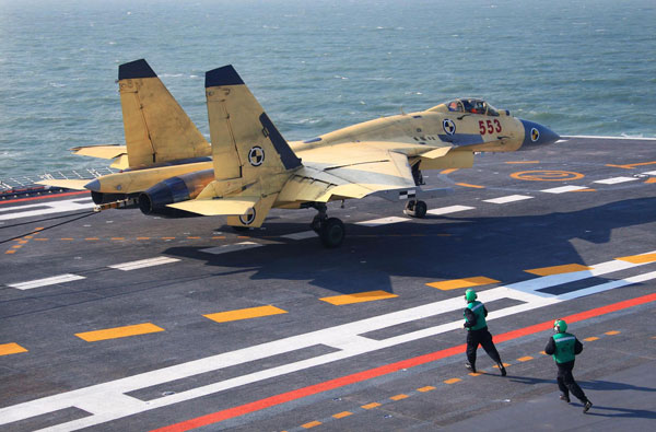 China conducts flight landing on aircraft carrier