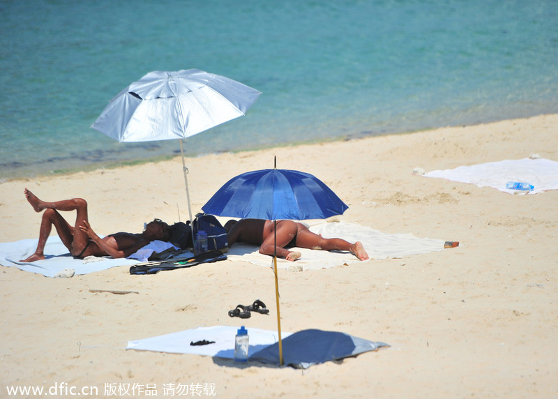 Two detained for swimming, sunbathing in the nude