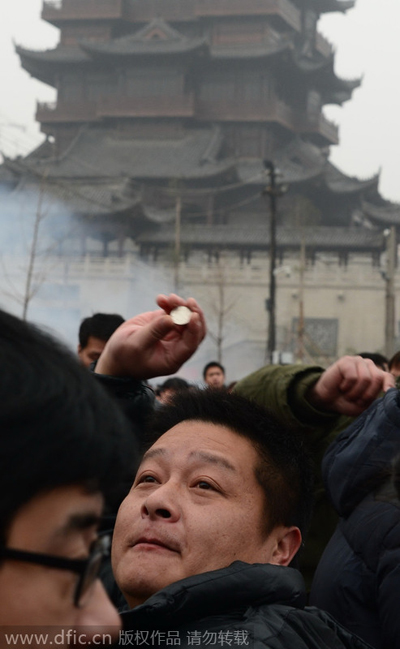 Throwing coins to please God of Wealth