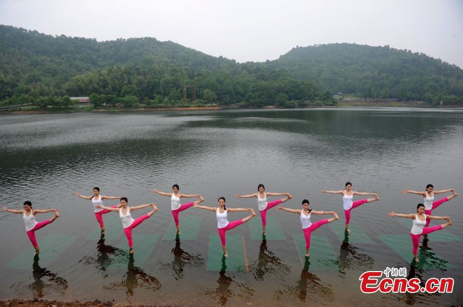 Yoga enthusiasts dance in water