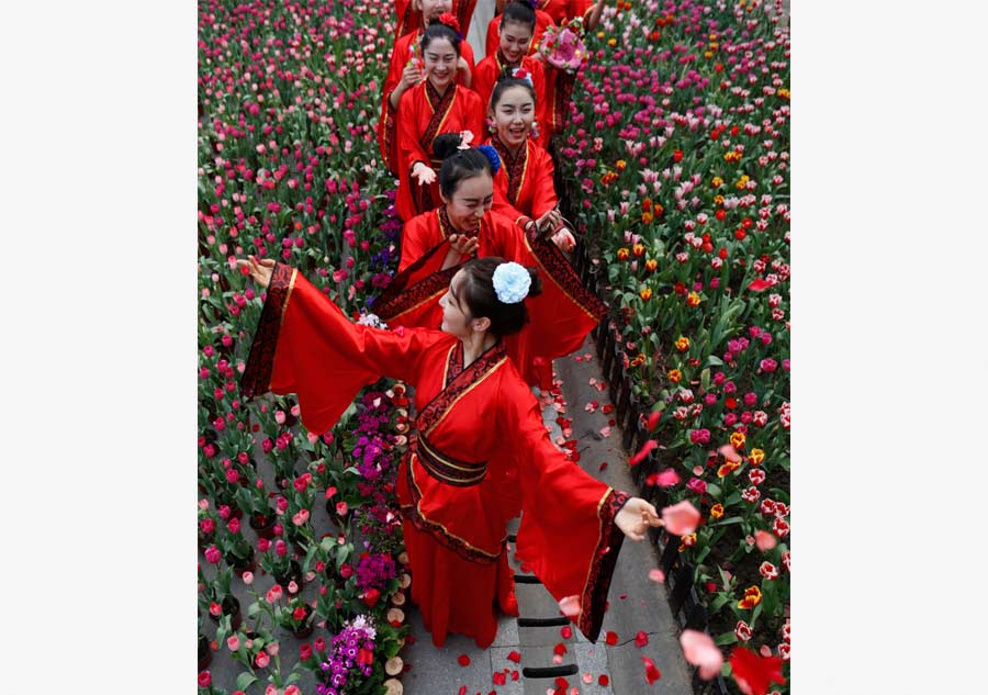 Students in traditional dresses celebrate Women's Day