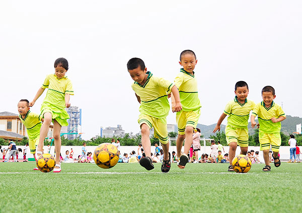 Kicking the ball: Kindergarten children play soccer