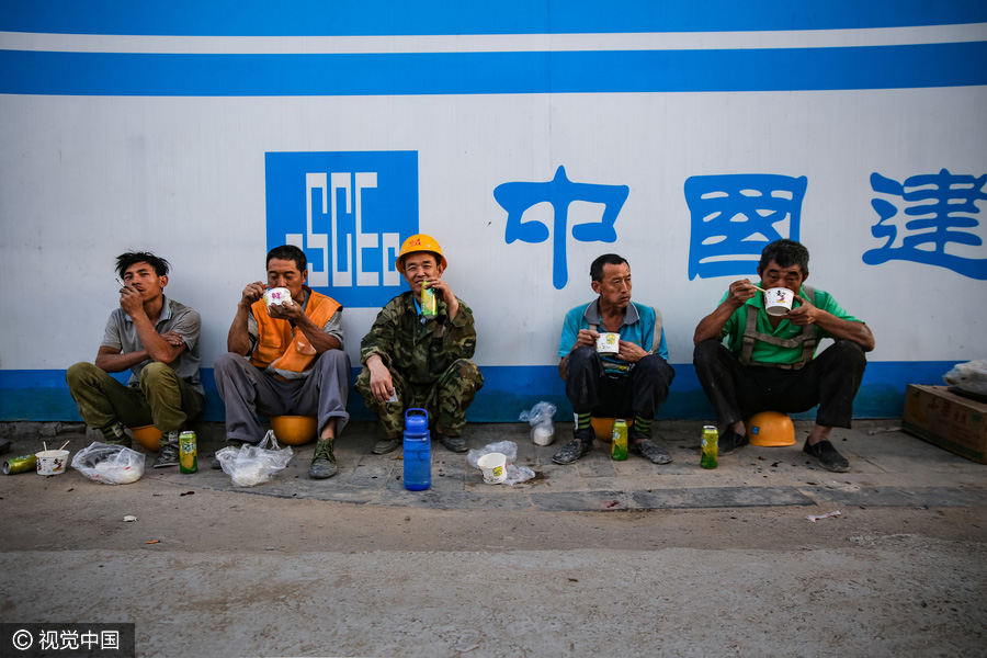 Workers behind Beijing's tallest building