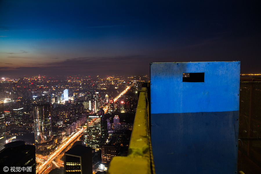 Workers behind Beijing's tallest building