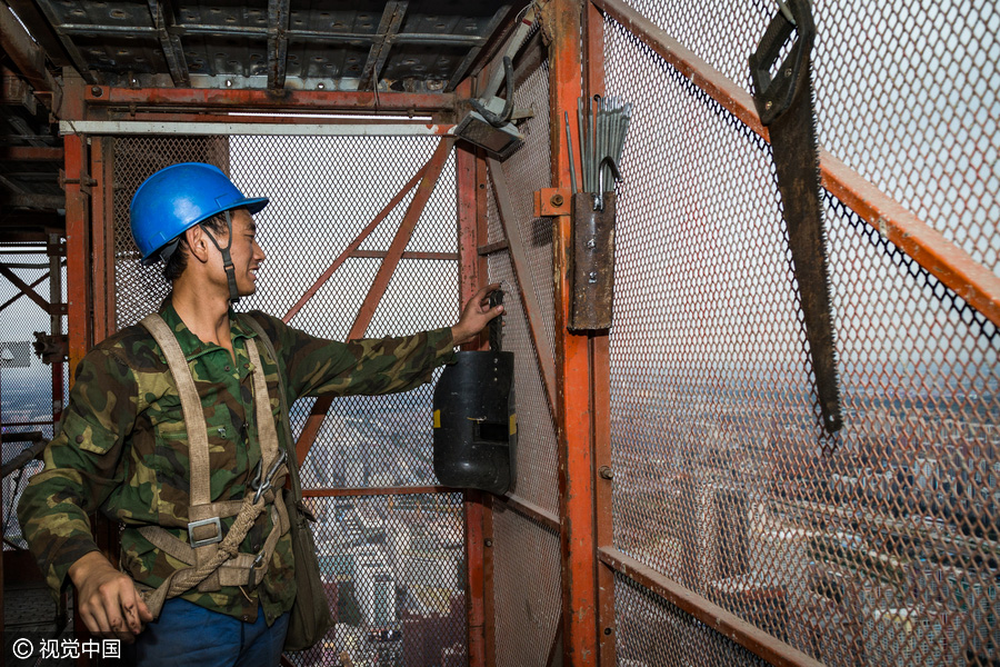 Workers behind Beijing's tallest building