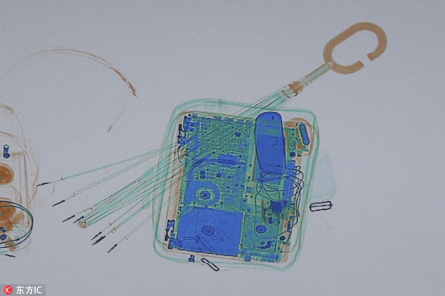 X-ray scanner reveals passangers' luggage for home journey during Spring Festival