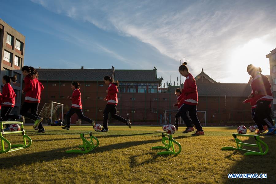 Primary school students participate in soccer training