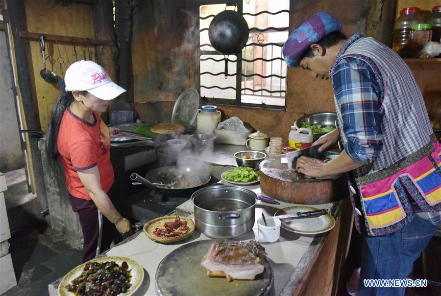 Nu ethnic couple and their family stay in SW China's village