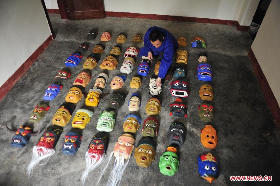 Folk artisan works on Nuo Opera masks