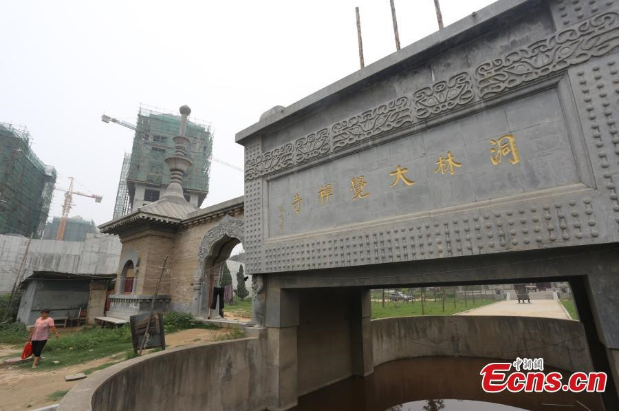 1,800-year-old temple under siege from high buildings in C China