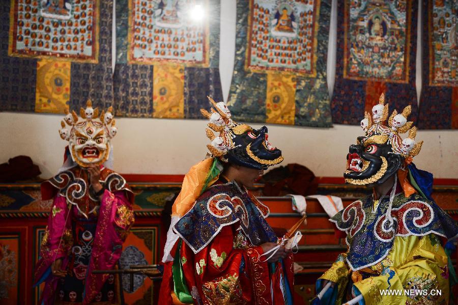 Monks wearing masks rehearse Gesar opera at Chalang Temple in NW China