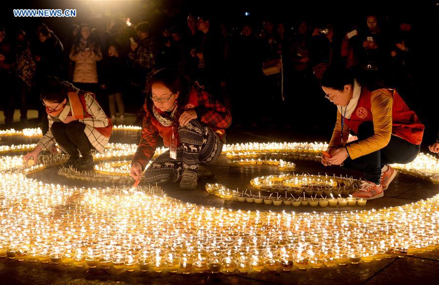 People pray for good luck at Guangren Temple in NW China