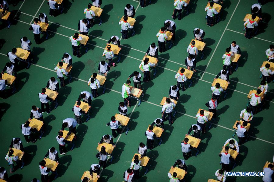 Pupils play Chinese chess during activity in NE China