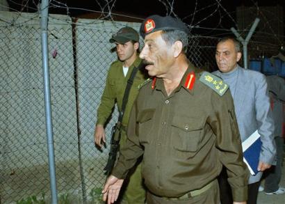 Palestinian police officer Zohair Abu Fateh arrives at the District Coordination Office in the West Bank town of Tulkarem for a meeting with Israeli officials Sunday, March 20, 2005. Israeli and Palestinian commanders met Sunday evening to work out the last details of a handover of Tulkarem, the second of five towns to be transferred to Palestinian control, but the session ended without agreement, a new hitch for fledgling peace efforts between the two sides. [AP]