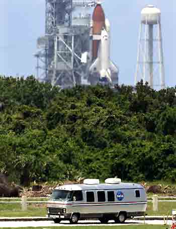 Space shuttle Discovery astronauts return to their crew quarters in the astronaut van after launch was delayed at the Kennedy Space Center in Cape Canaveral, Florida, July 13, 2005. [Reuters]