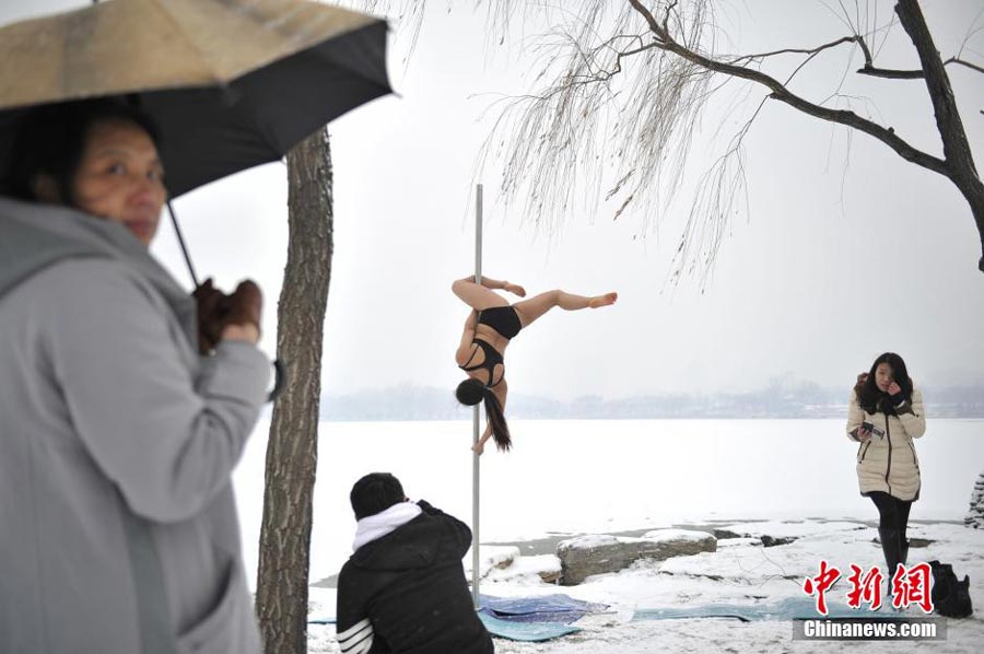 Pole dancers practice outside in cold winter