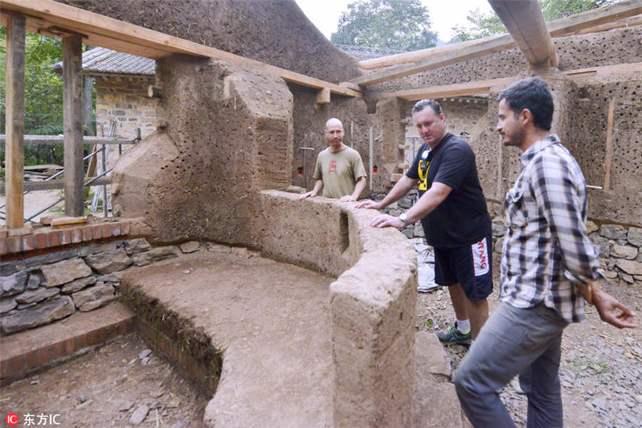 US man building mud house in rural China