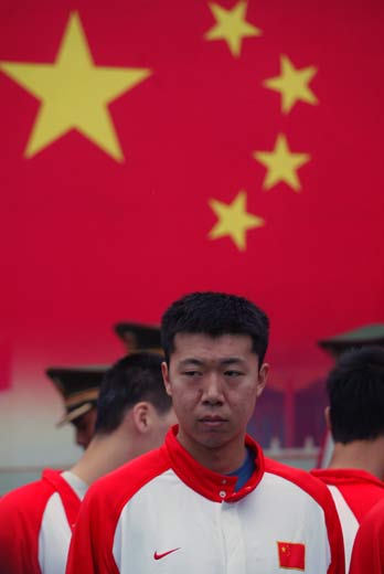 Basketball player Wang Zhizhi attends a flag-raising ceremony with his teammates at the Tiananmen Square in Beijing May 8, 2006. China's first NBA star Wang has earned a recall to the national team after four years in the wilderness following his refusal to play in the 2002 Asian Games. Wang paved the way for Chinese NBA players Yao Ming and Menk Barteer when he signed for the Dallas Mavericks in 2001, but the center was expelled from the national squad for opting out of representing China in Busan, South Korea four years ago. [Newsphoto]