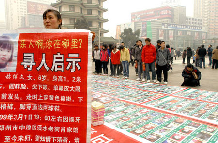 Poster with photos of 2,700 missing children