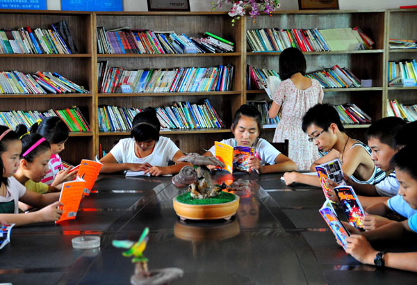 Left-behind children reading in village library