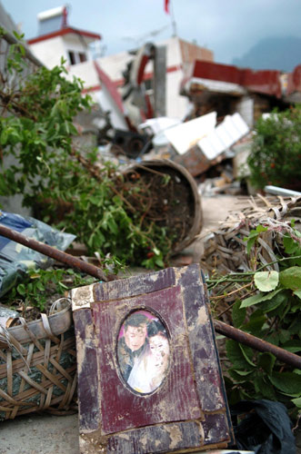 Personal items lie amid muddy ruins