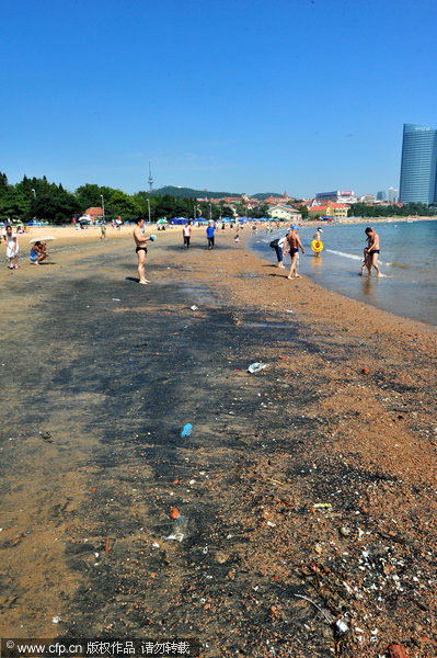 E China beach covered by unknown black substance