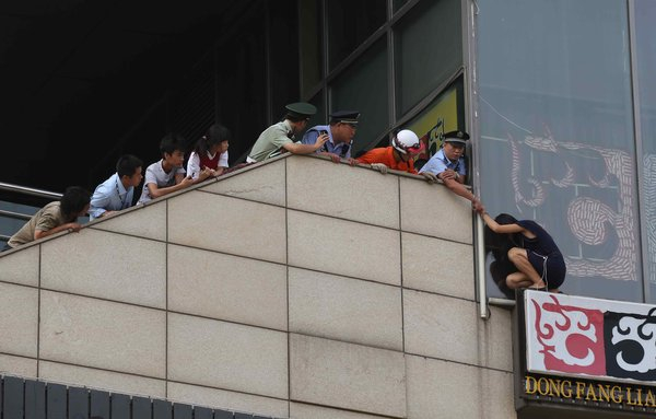 Woman pulled off the ledge in Beijing