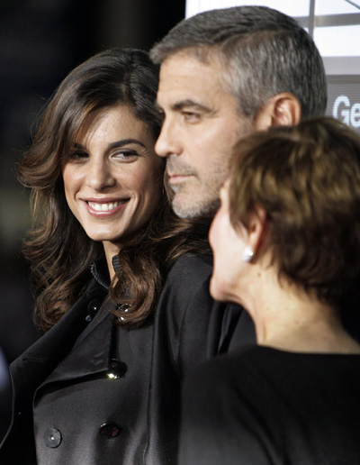 George Clooney and his girlfriend pose at the premiere of 