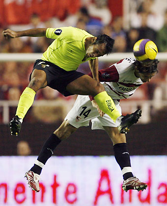 Sevilla's Julien Escud?(R) of France and Braga's Ze Carlos of Brazil head the ball during their UEFA Cup soccer match at Ramon Sanchez Pizjuan stadium in Seville November 23, 2006. 