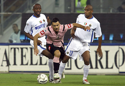 Inter Milan's Adriano and Palermo's Paolo Dellafiore (R) fight for the ball during their Italian Serie A soccer match at the Renzo Barbera Stadium in Palermo November 26, 2006. 