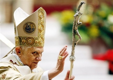 Pope Benedict XVI delivers his blessing as he leaves St.Peter's Basilica at the Vatican after celebrating the Christmas Midnight Mass, early Monday, Dec. 25, 2006. (AP 